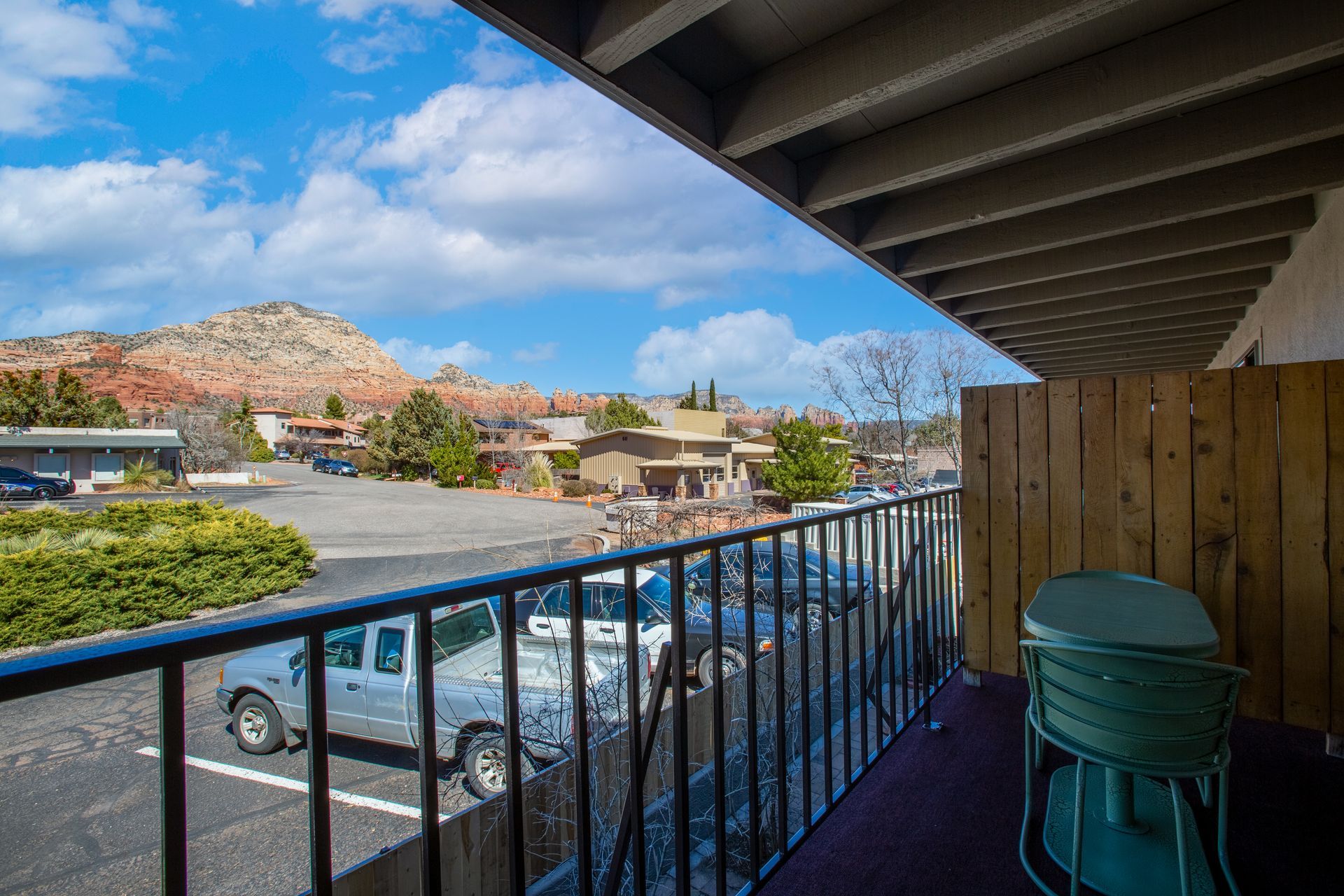 Balcony at Dreamcatcher Inn Sedona overlooking parking area and scenic mountain views