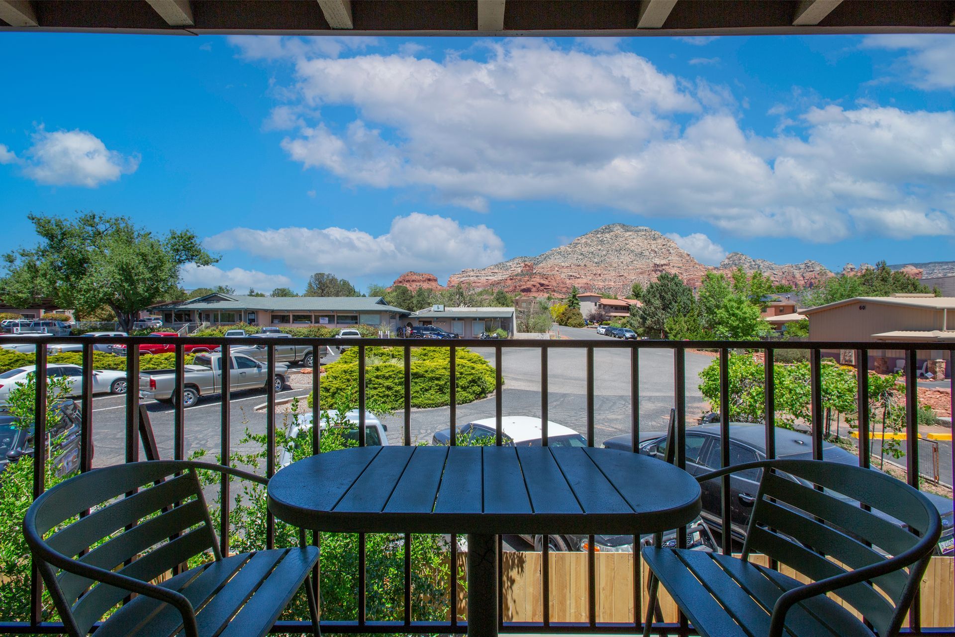 Dreamcatcher Inn Sedona private balcony with mountain views, outdoor table, and chairs for relaxing stays