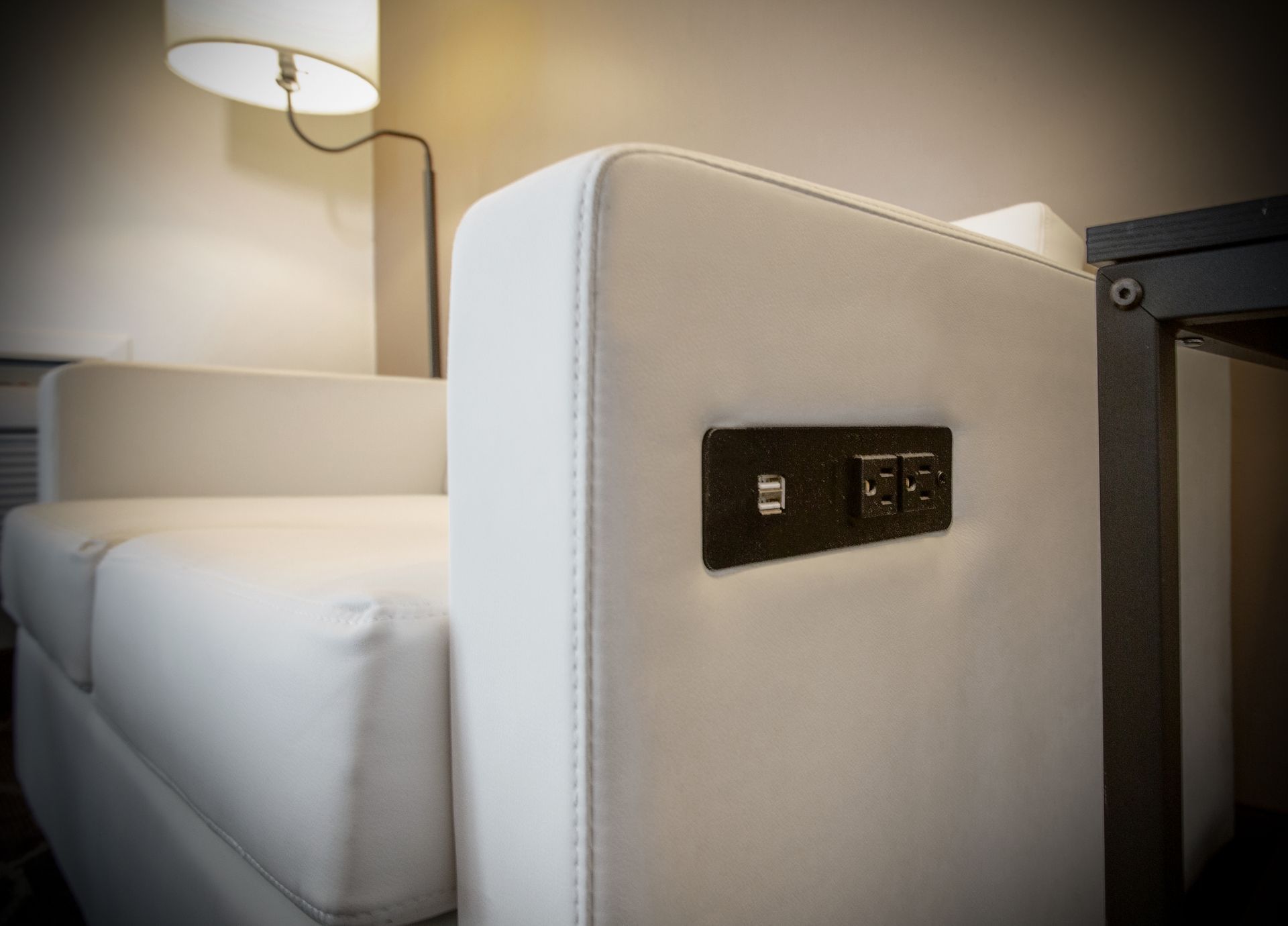 White couch with side table and lamp in a cozy seating area at Dreamcatcher Inn Sedona
