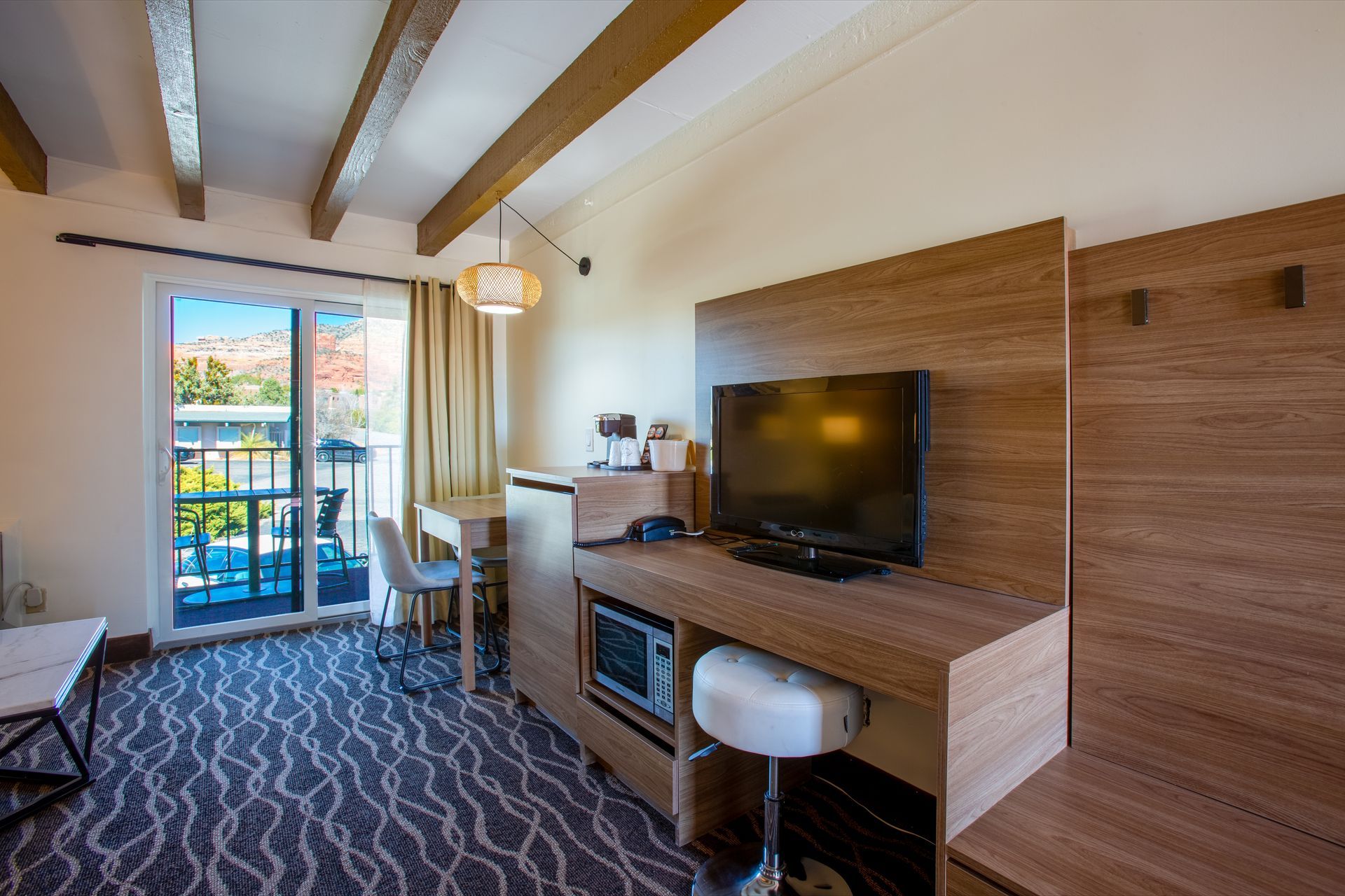 Dreamcatcher Inn Sedona hotel room with flat-screen TV and private balcony overlooking scenic views