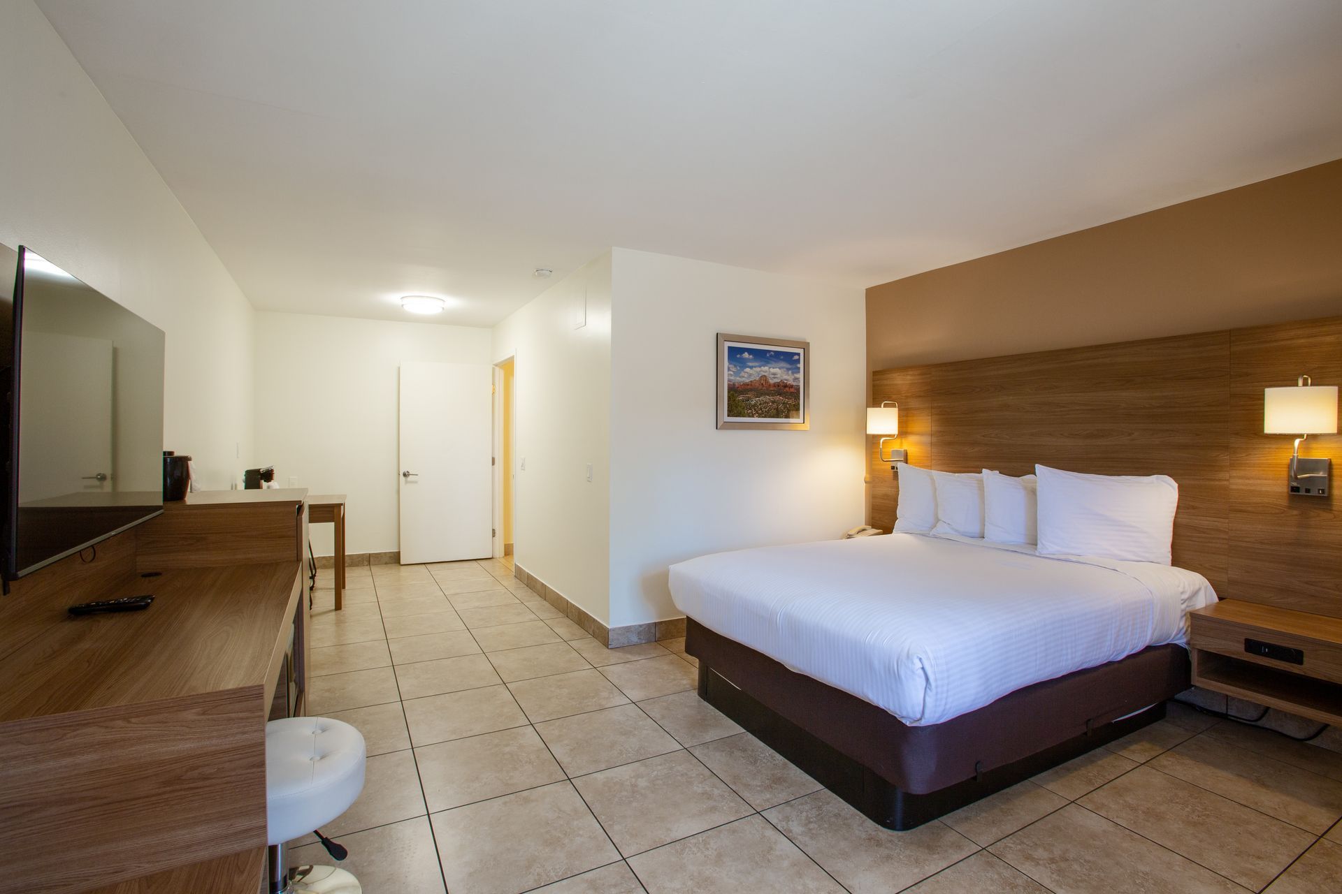 Spacious Dreamcatcher Inn Sedona hotel room with king-size bed and wall-mounted flat-screen TV