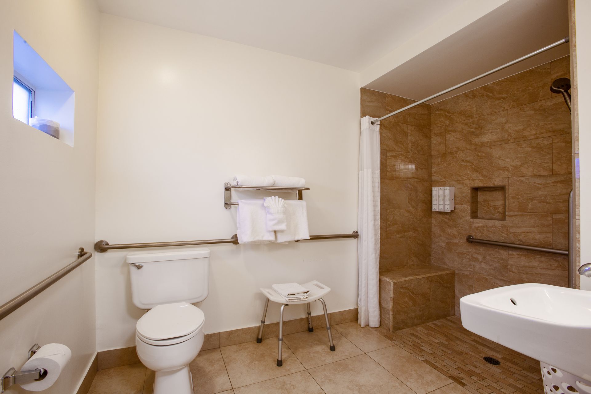 Modern bathroom at Dreamcatcher Inn Sedona with toilet, sink, and walk-in shower