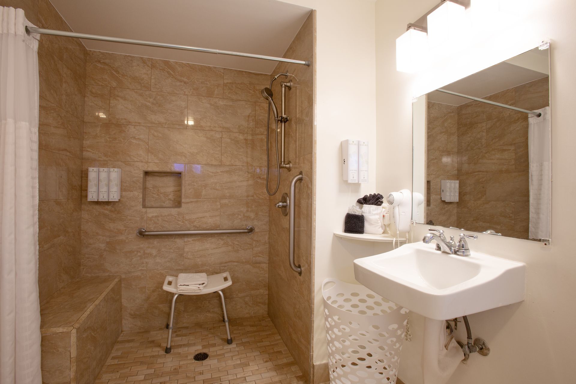 Dreamcatcher Inn Sedona bathroom featuring walk-in shower, sink, and large mirror