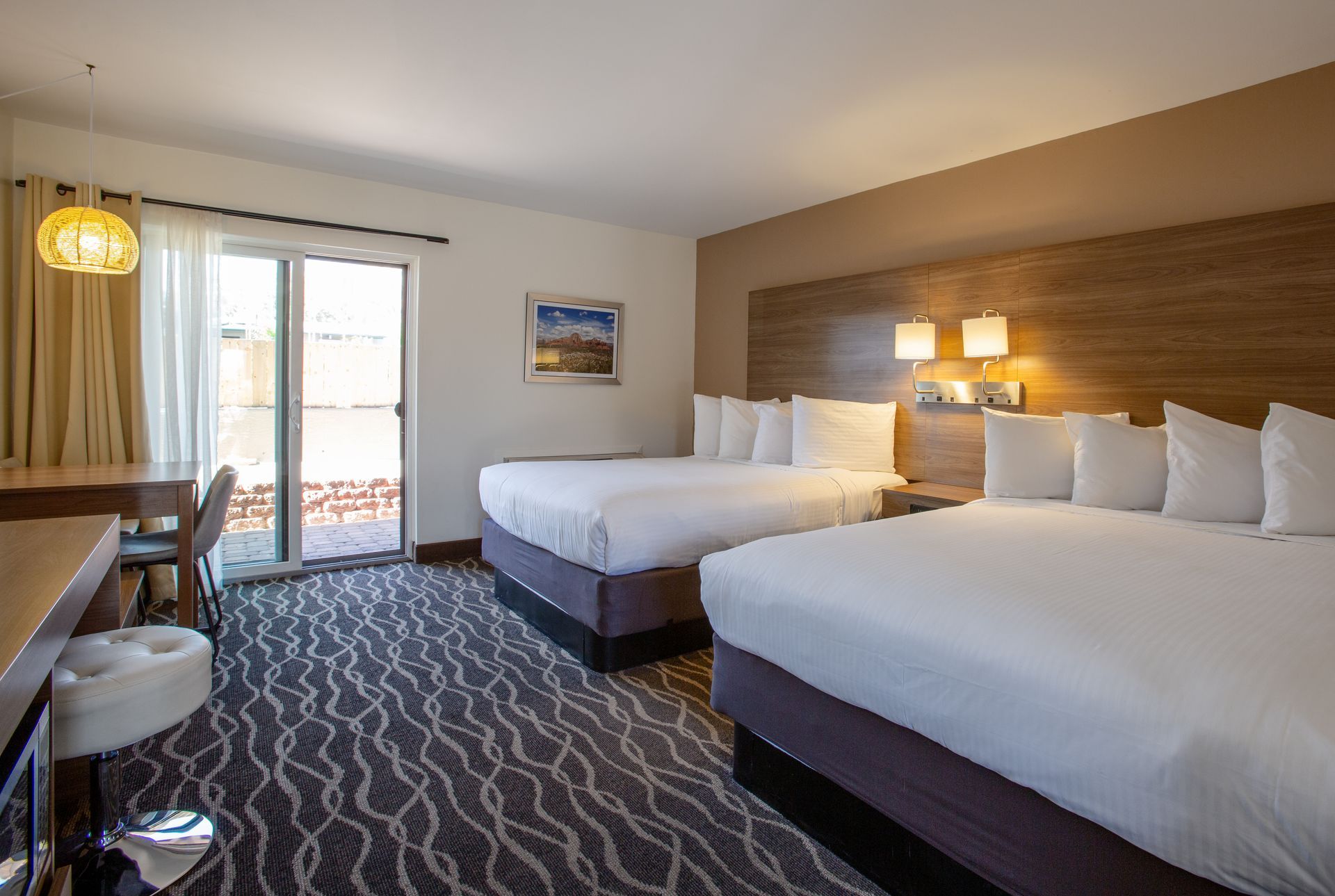 Dreamcatcher Inn Sedona hotel room with two beds and sliding glass door leading to scenic views