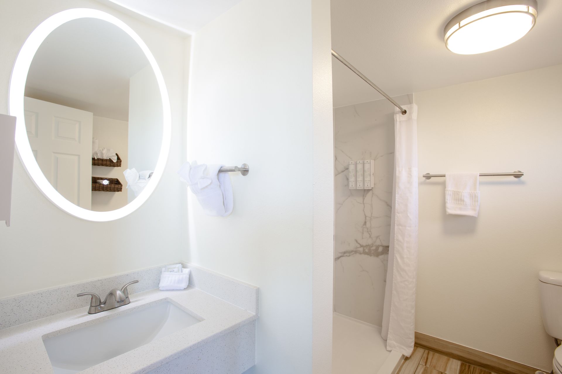 Modern Dreamcatcher Inn Sedona bathroom with sink, toilet, walk-in shower, and large mirror