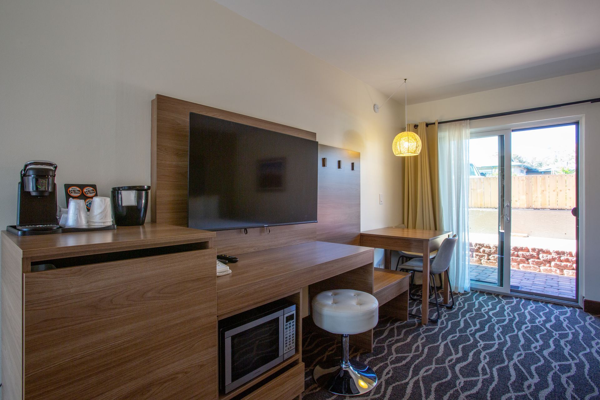 Dreamcatcher Inn Sedona hotel room with flat-screen TV, microwave, work desk, and chairs