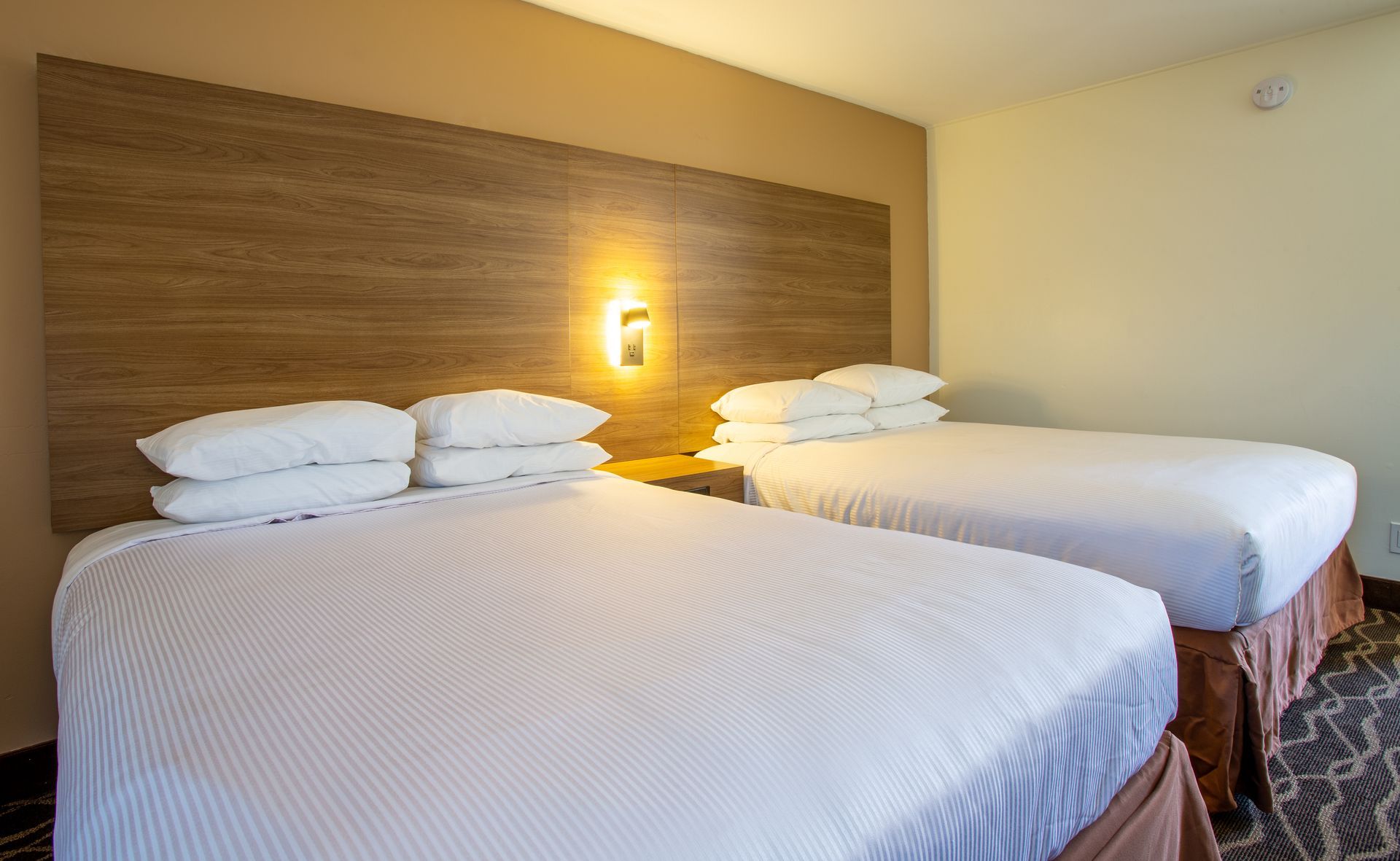 Dreamcatcher Inn Sedona hotel room with two beds and rustic wooden headboards