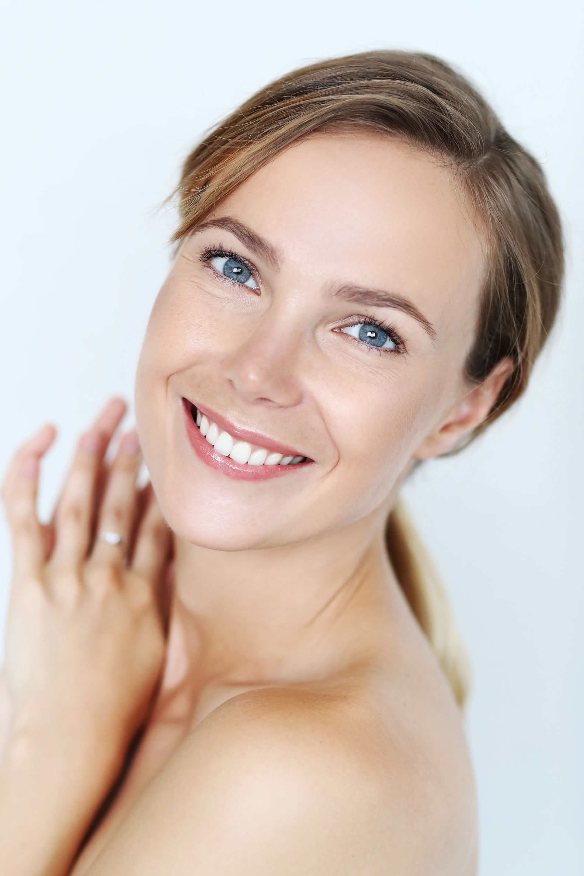 A close up of a woman 's face with a smile on her face.