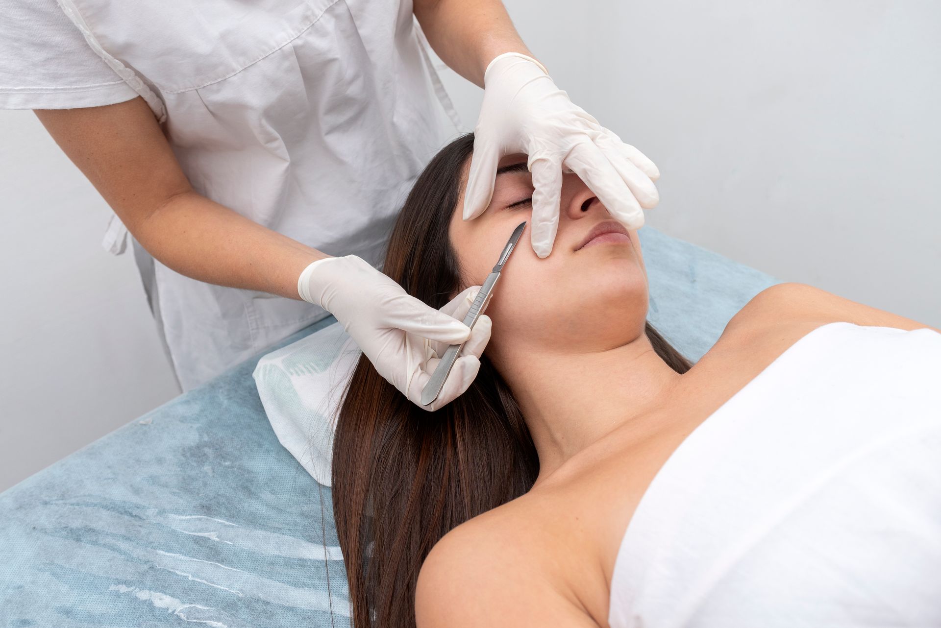 A woman is getting a facial treatment at a beauty salon.