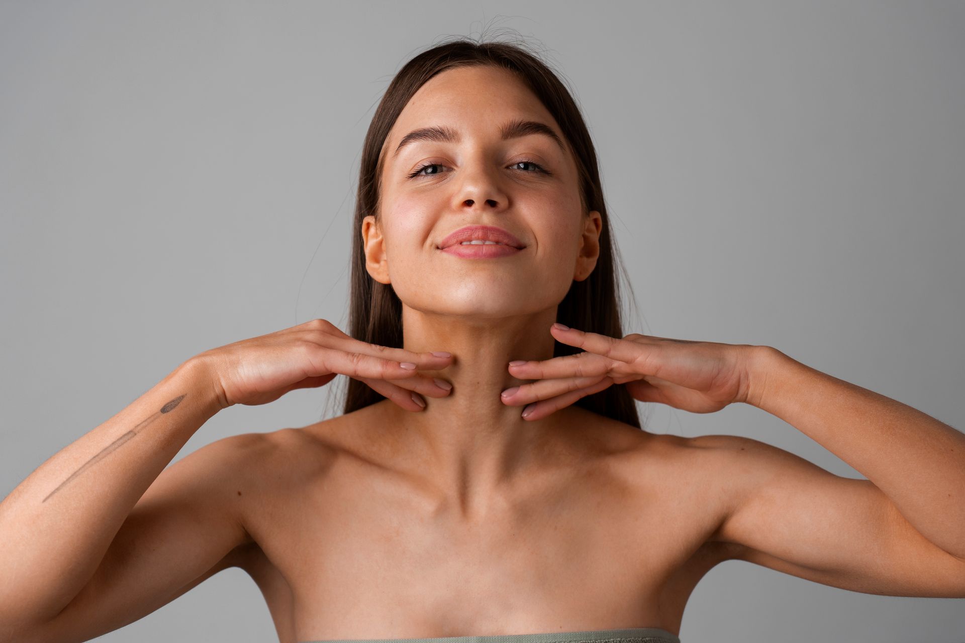 a woman touching her face with her hands.