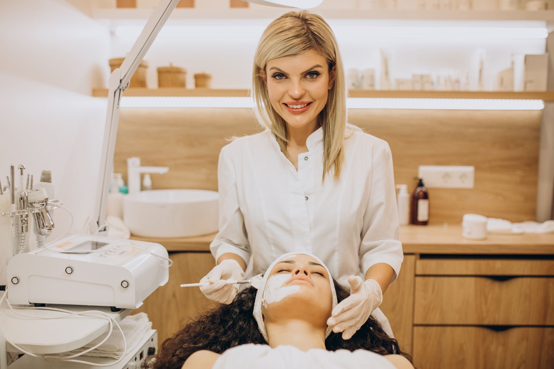 A woman is getting a facial treatment at a beauty salon.