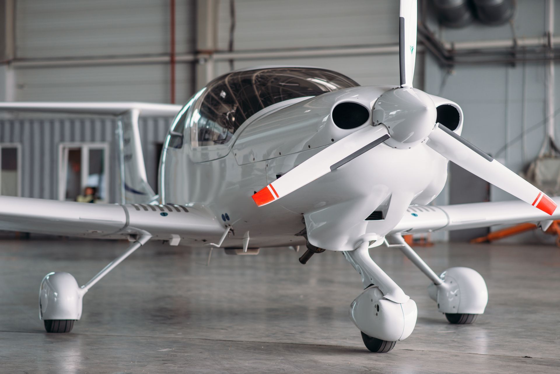 A small propeller plane is parked in a hangar.
