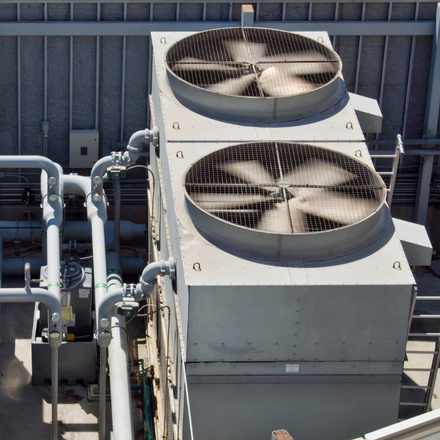 A row of air conditioners on top of a building