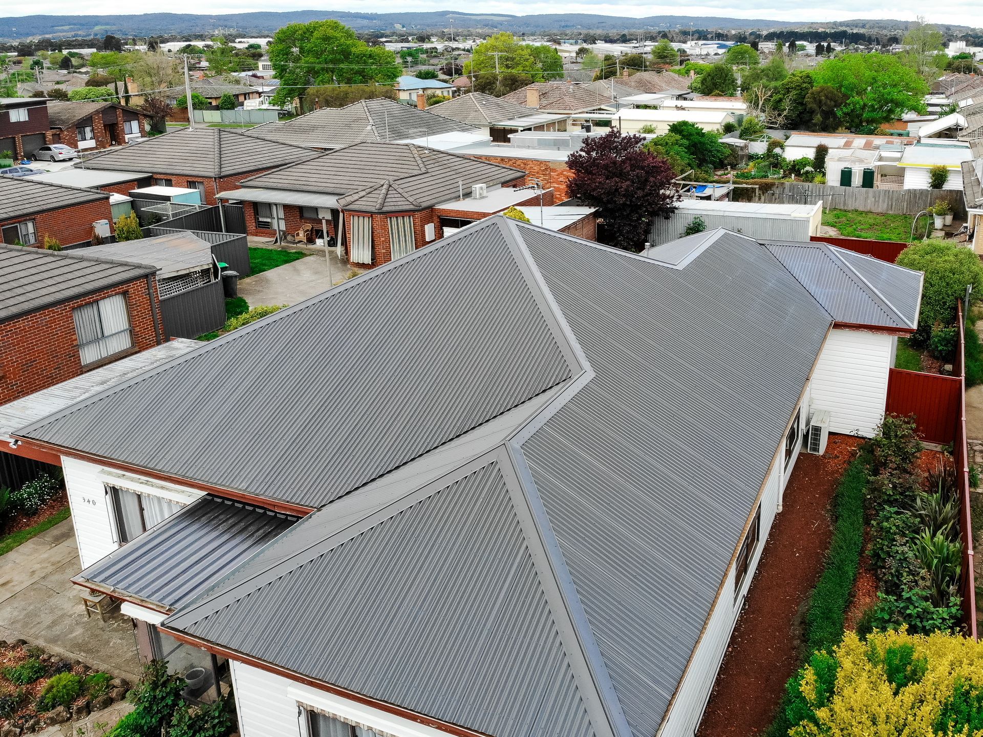 After, new Colorbond® metal roof with fresh ridge cappings on the same weatherboard home, Wendouree VIC.