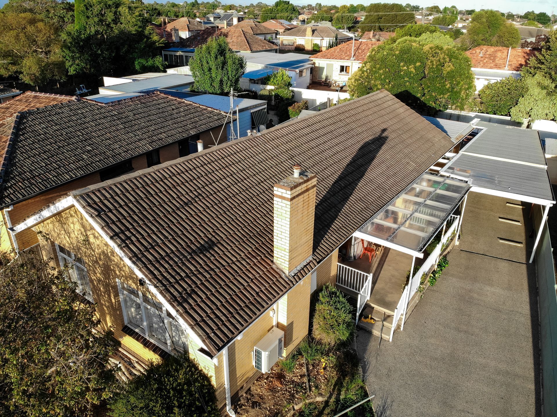 Before, worn concrete tile roof on brick-veneer home, Bendigo VIC.