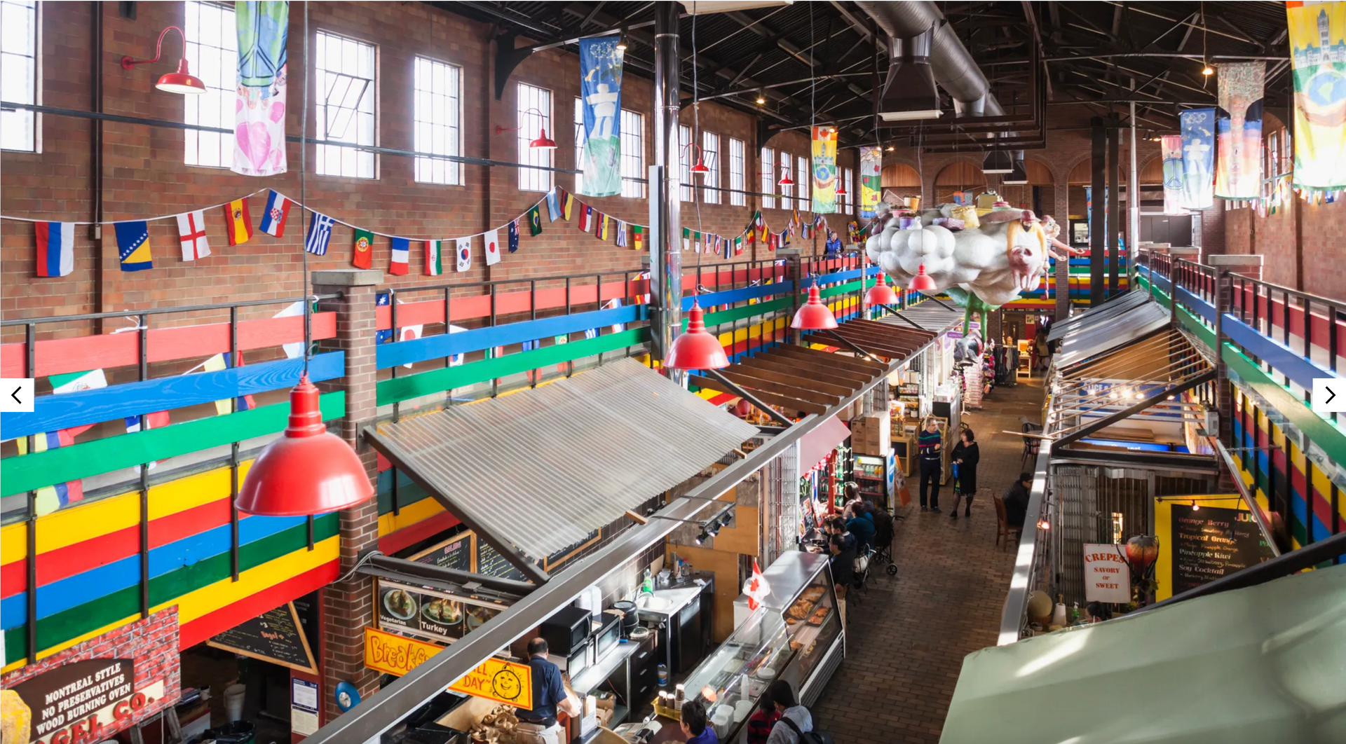 The inside of a building with flags hanging from the ceiling