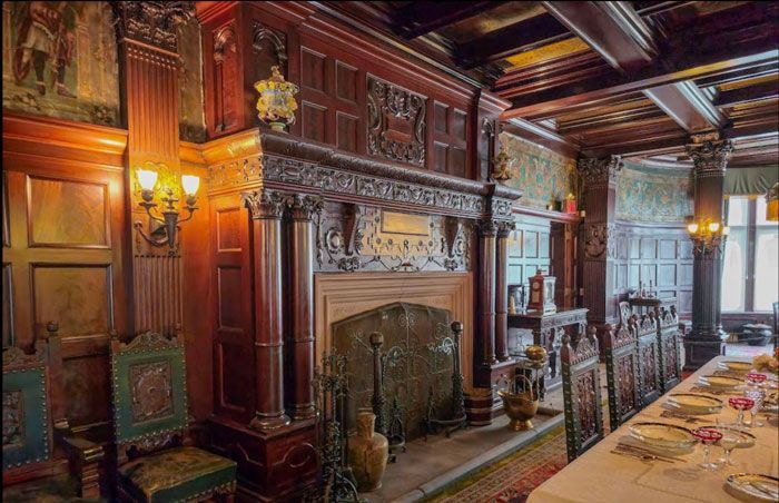 A dining room with a table and chairs and a fireplace