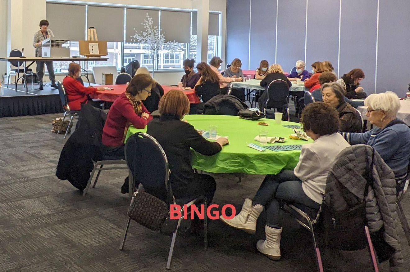A group of women sitting around a table with the word bingo on the bottom