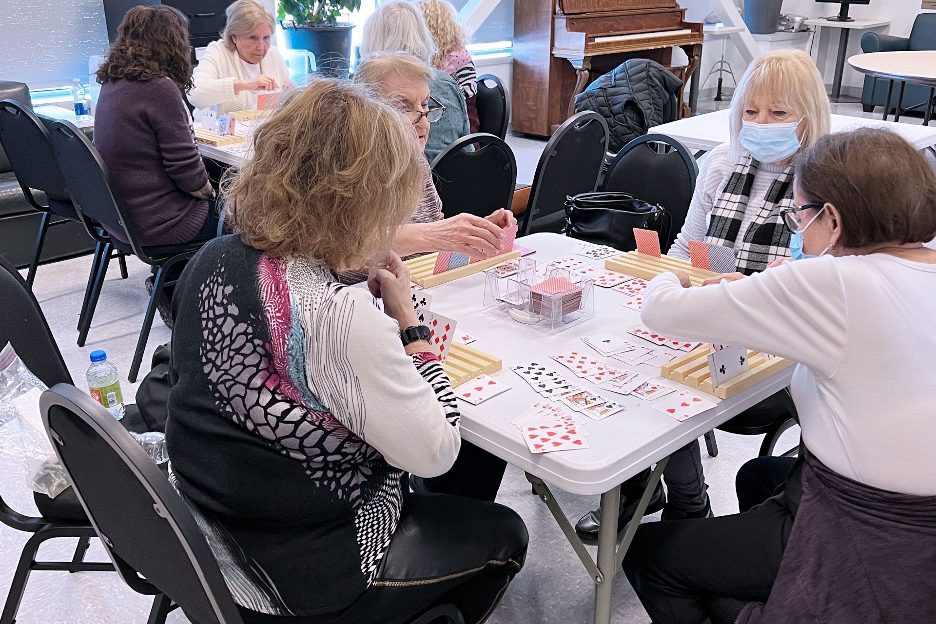 Women sitting at a table playing Canasta