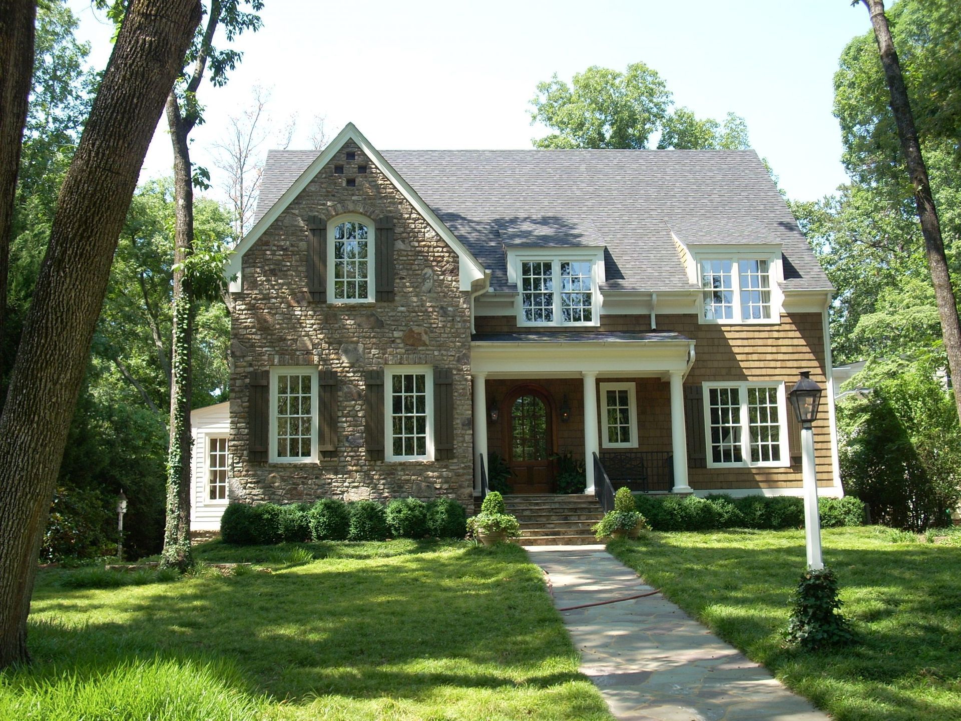 A large house with a stone walkway leading to it