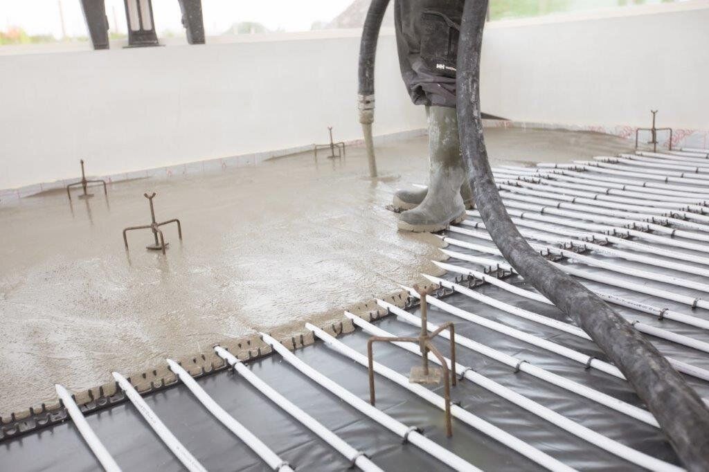 Colchester contractor - JC Flow Screeds - pumping liquid flow screed over heated flooring.