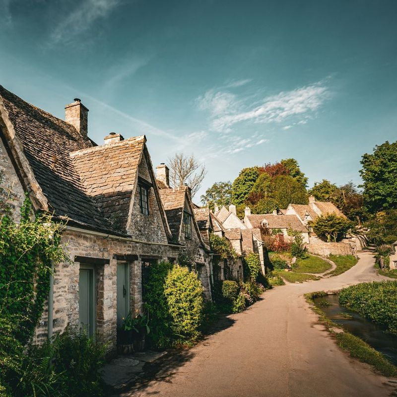 Honey-coloured stone cottages along a quiet village lane