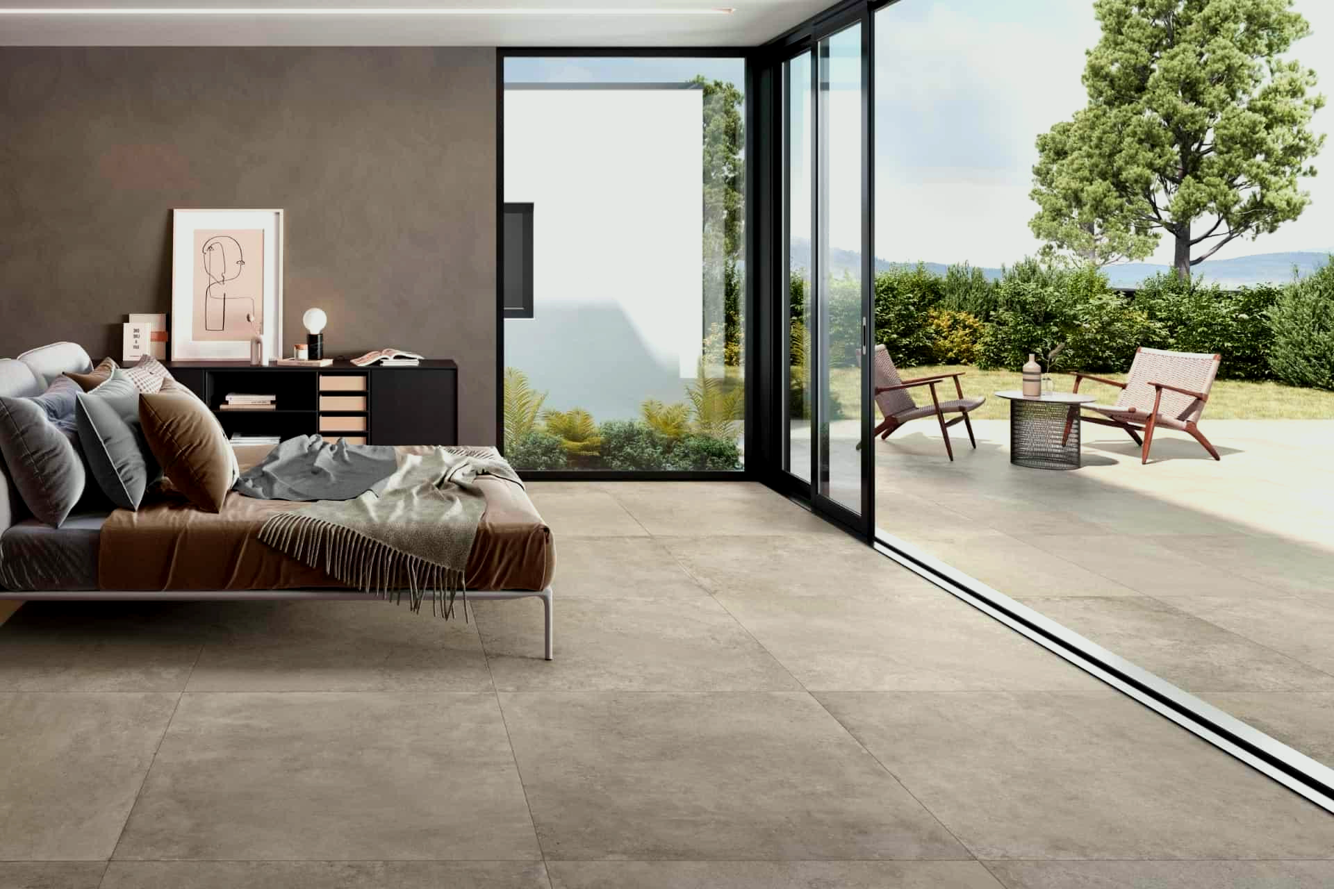 Modern living room with large sliding glass door opening to a patio, neutral tones, landscape view.