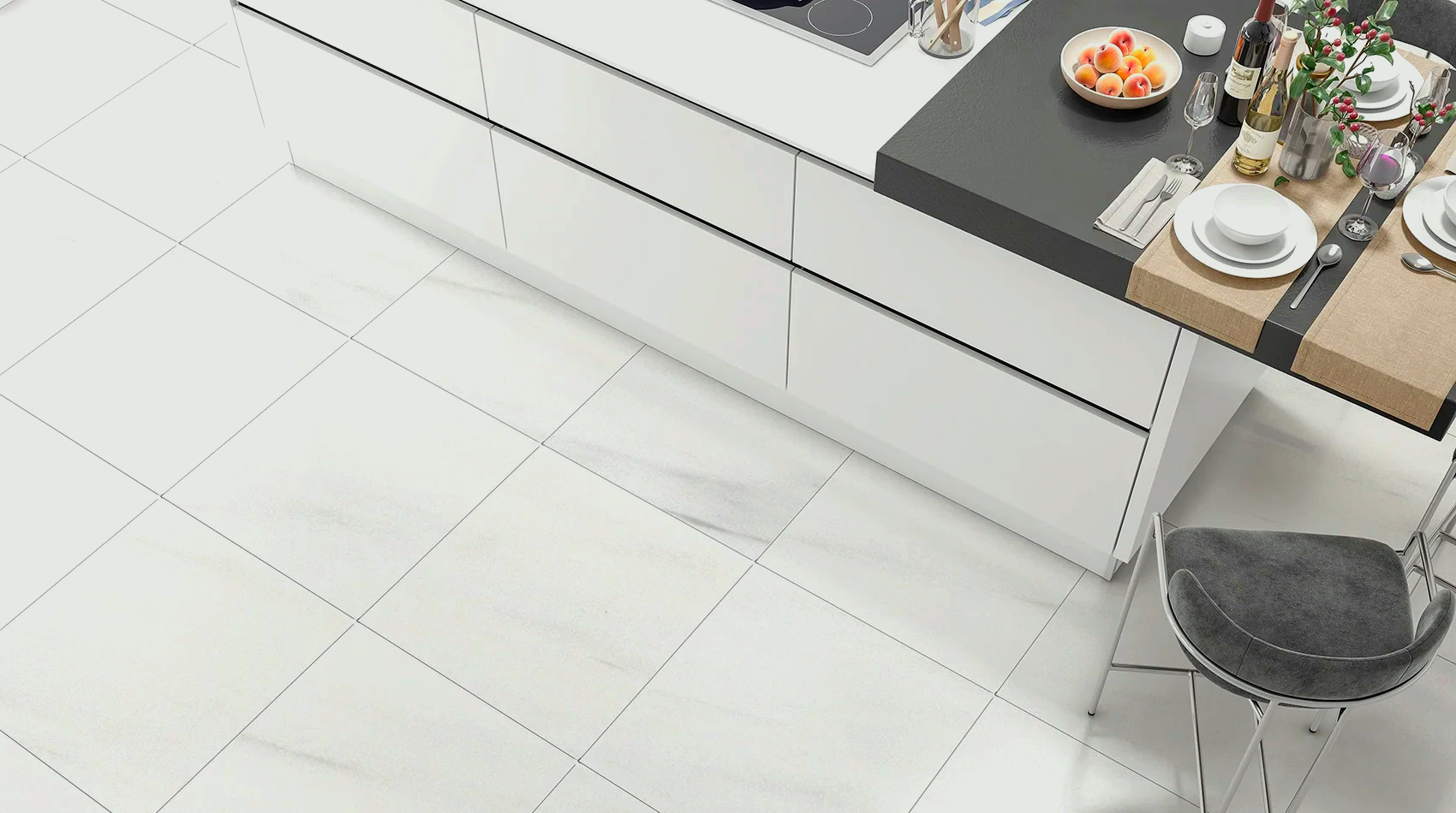 White kitchen with a breakfast bar, set for a meal; a stool is in front of the bar.