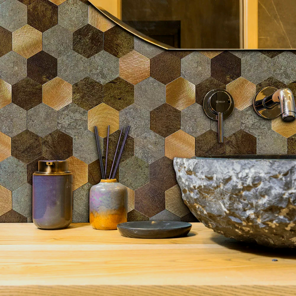 Bathroom with hexagon tiles, a stone sink, and decorative items on a wooden countertop.