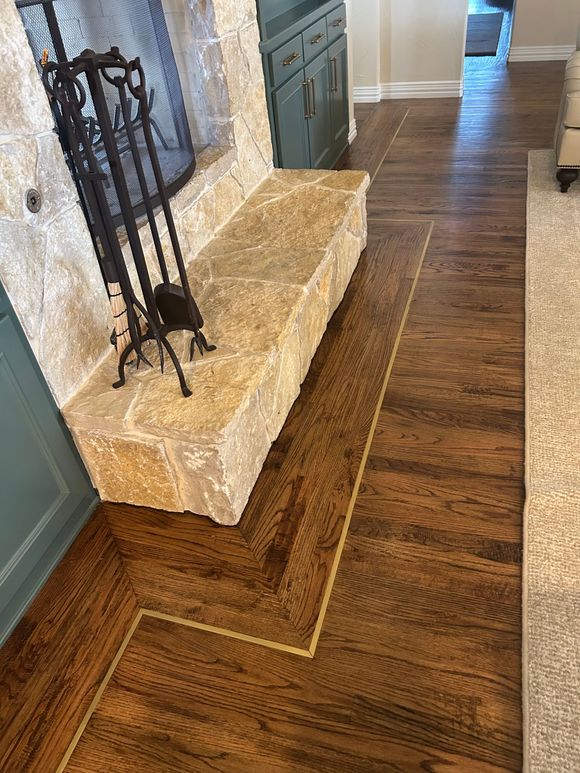Hardwood flooring installation around fireplace in Aledo, TX home