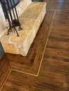 Hardwood flooring installation around fireplace in Aledo, TX home