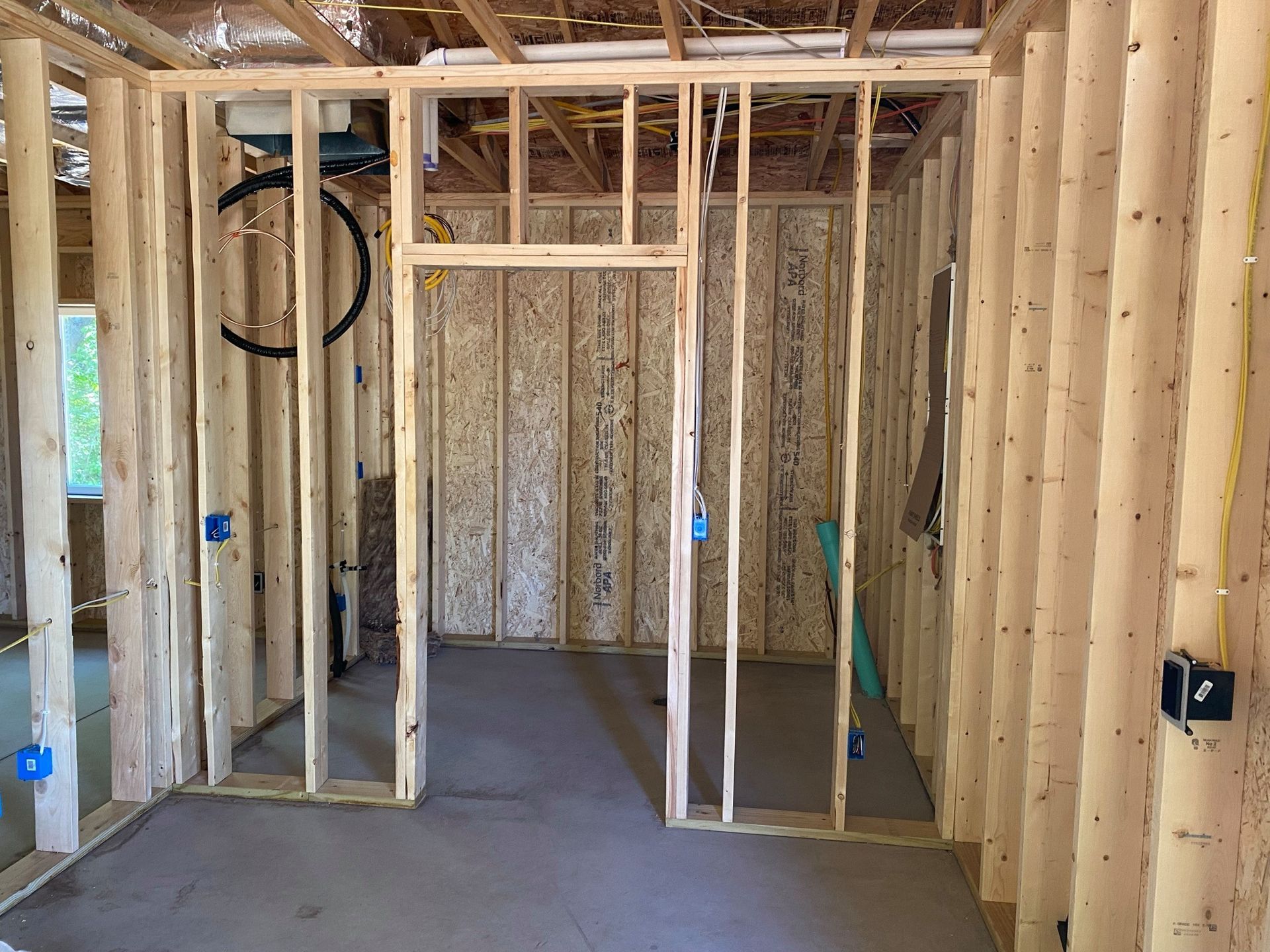 A room in a house that is being built with wooden beams.