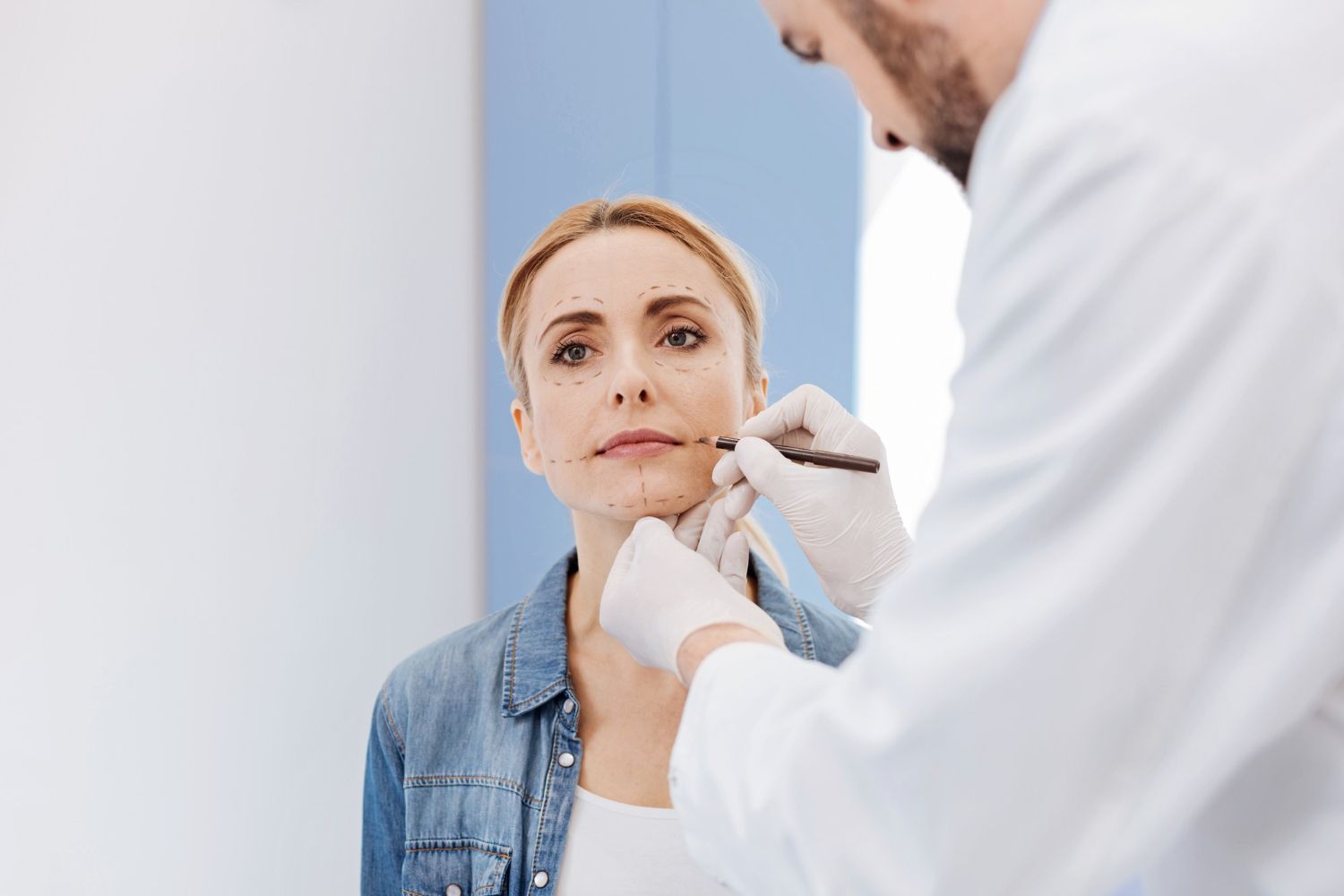 Patient undergoing an eye exam with a slit lamp while an optometrist examines her eyes