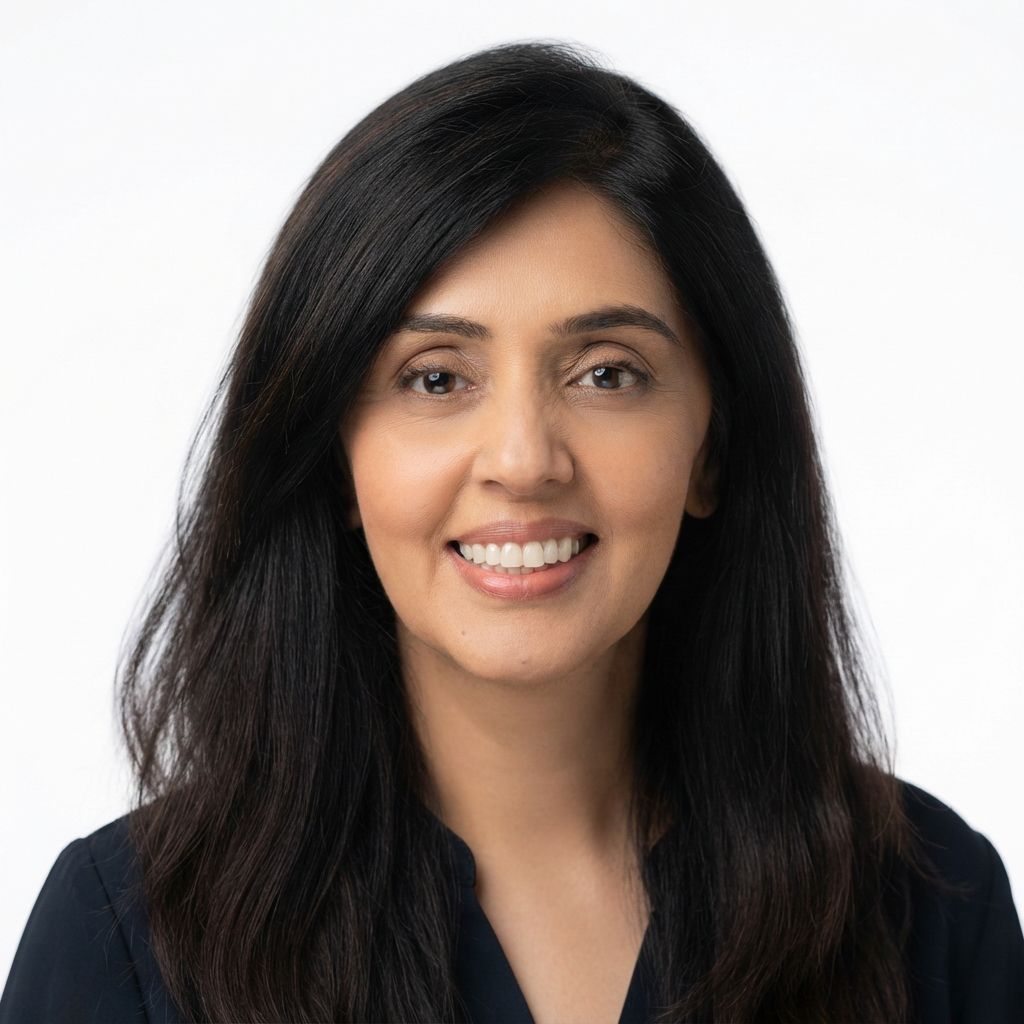 Smiling person with long dark hair against a white background