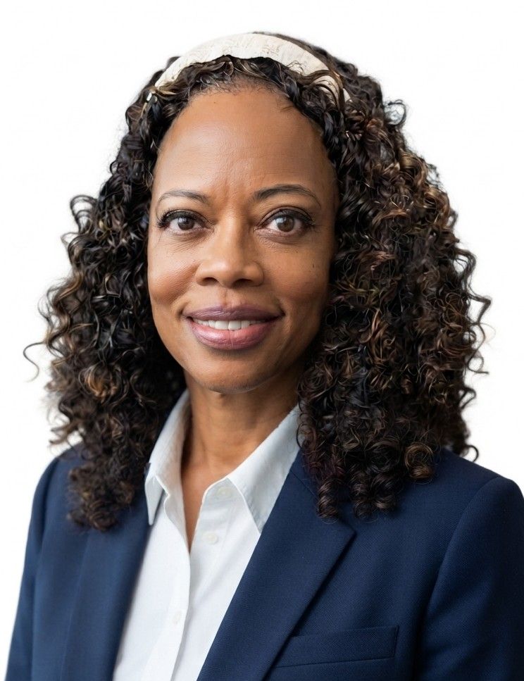 Professional headshot of a smiling woman in a navy blazer and white shirt on a white background