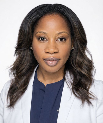 Studio headshot of a person in a white blazer over a navy blouse, facing forward with a neutral expression