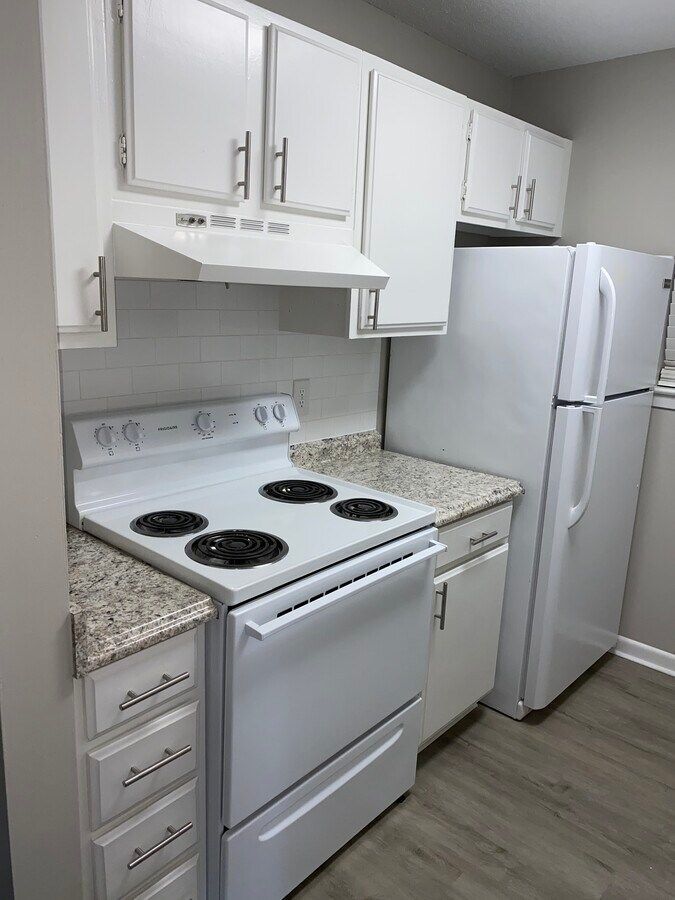 A kitchen with a stove , refrigerator , and dishwasher.