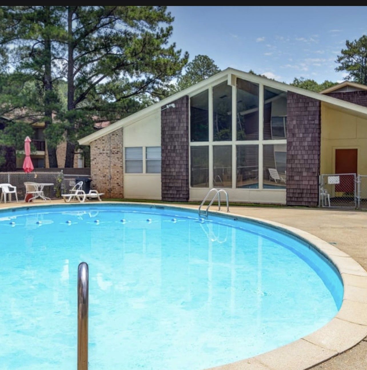 A large swimming pool in front of a house
