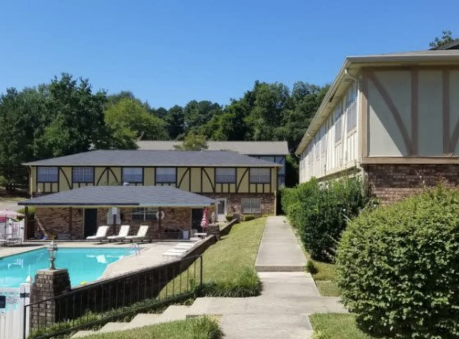 A building with a swimming pool in front of it