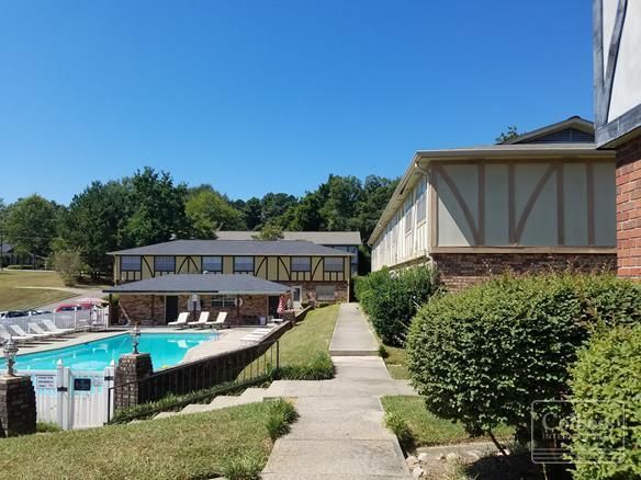 A building with a swimming pool in front of it