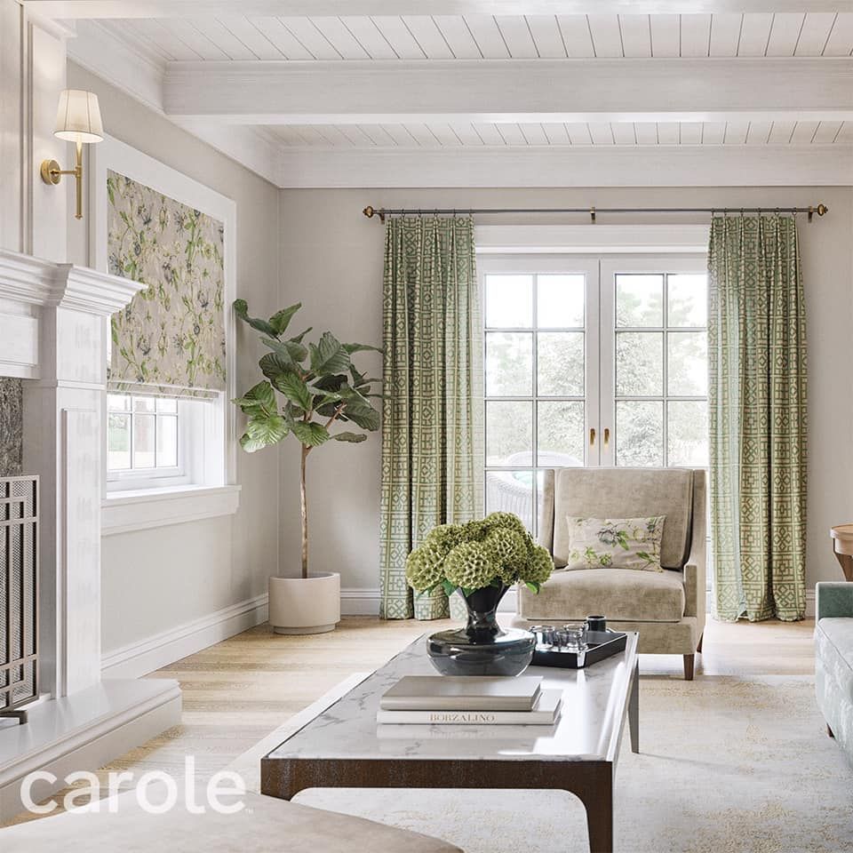 Bright, airy living room with green curtains, beige chair, white coffee table, and fireplace