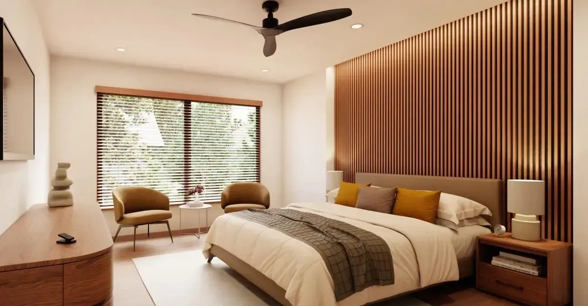 Modern bedroom with wooden slat accent wall, large window, bed, chairs, and ceiling fan