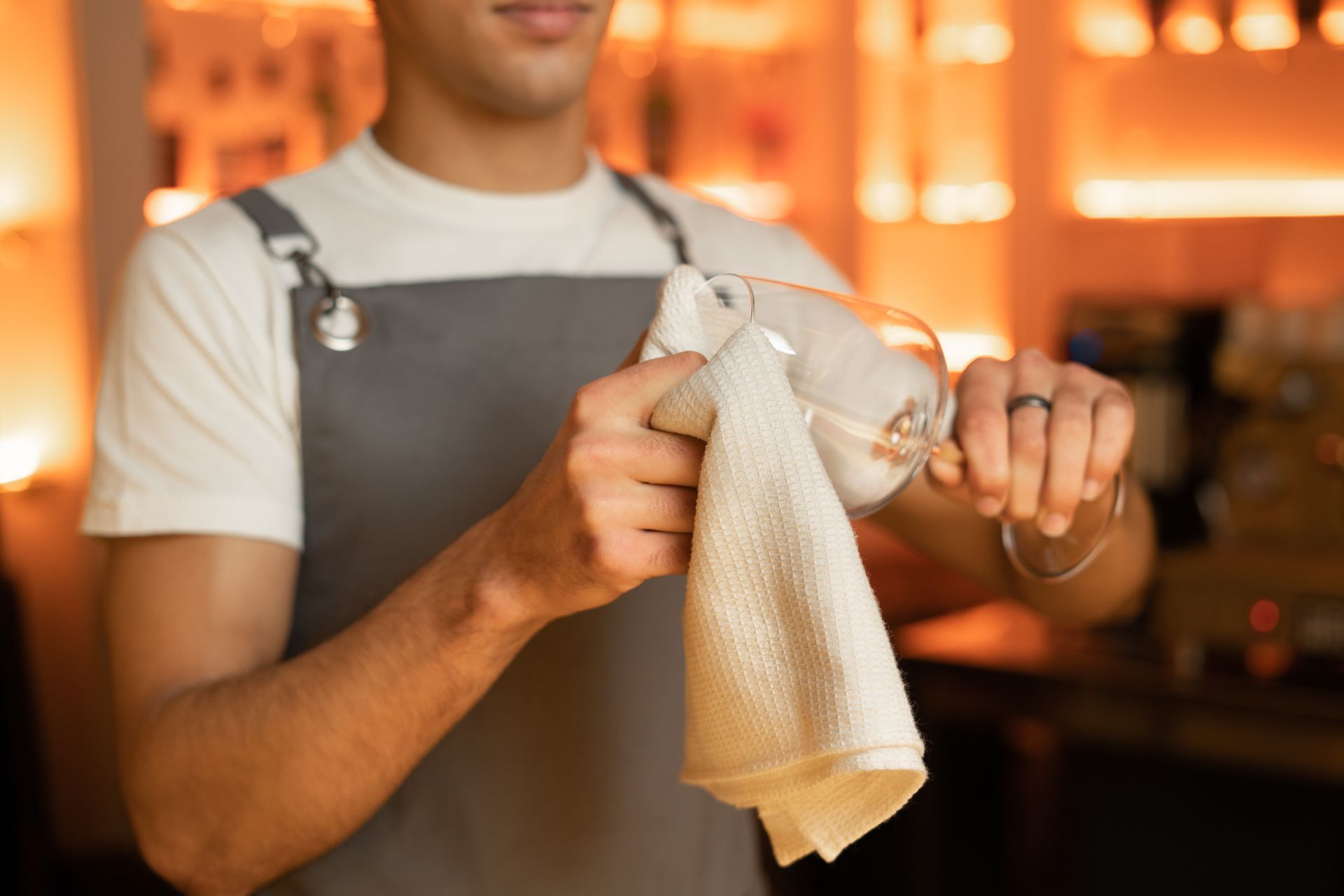 Bartender cleaning the wine glass