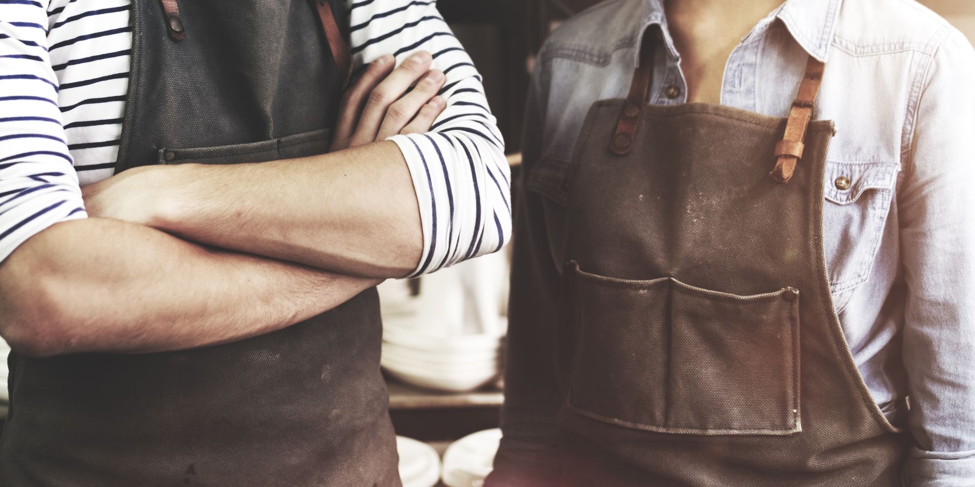 Couple wearing brown aprons