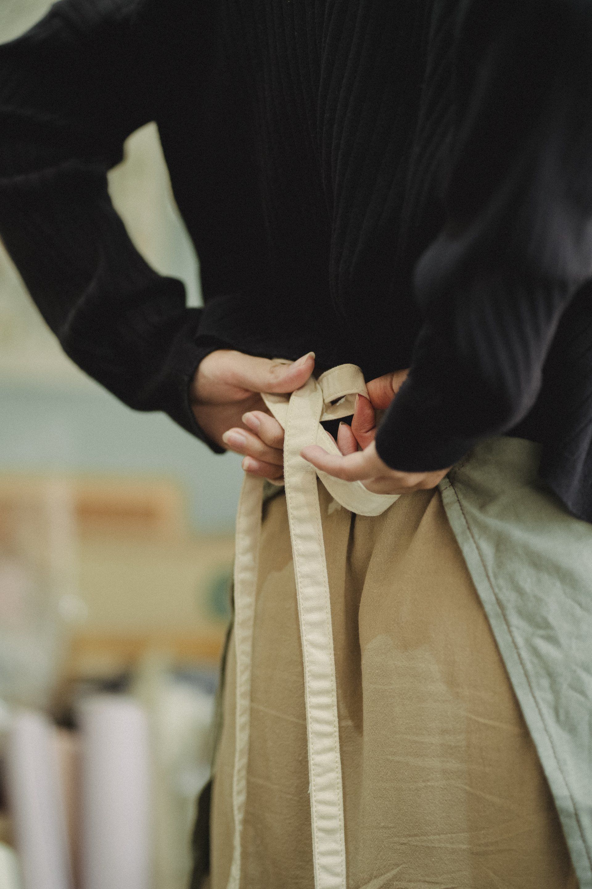 Woman tightening the apron