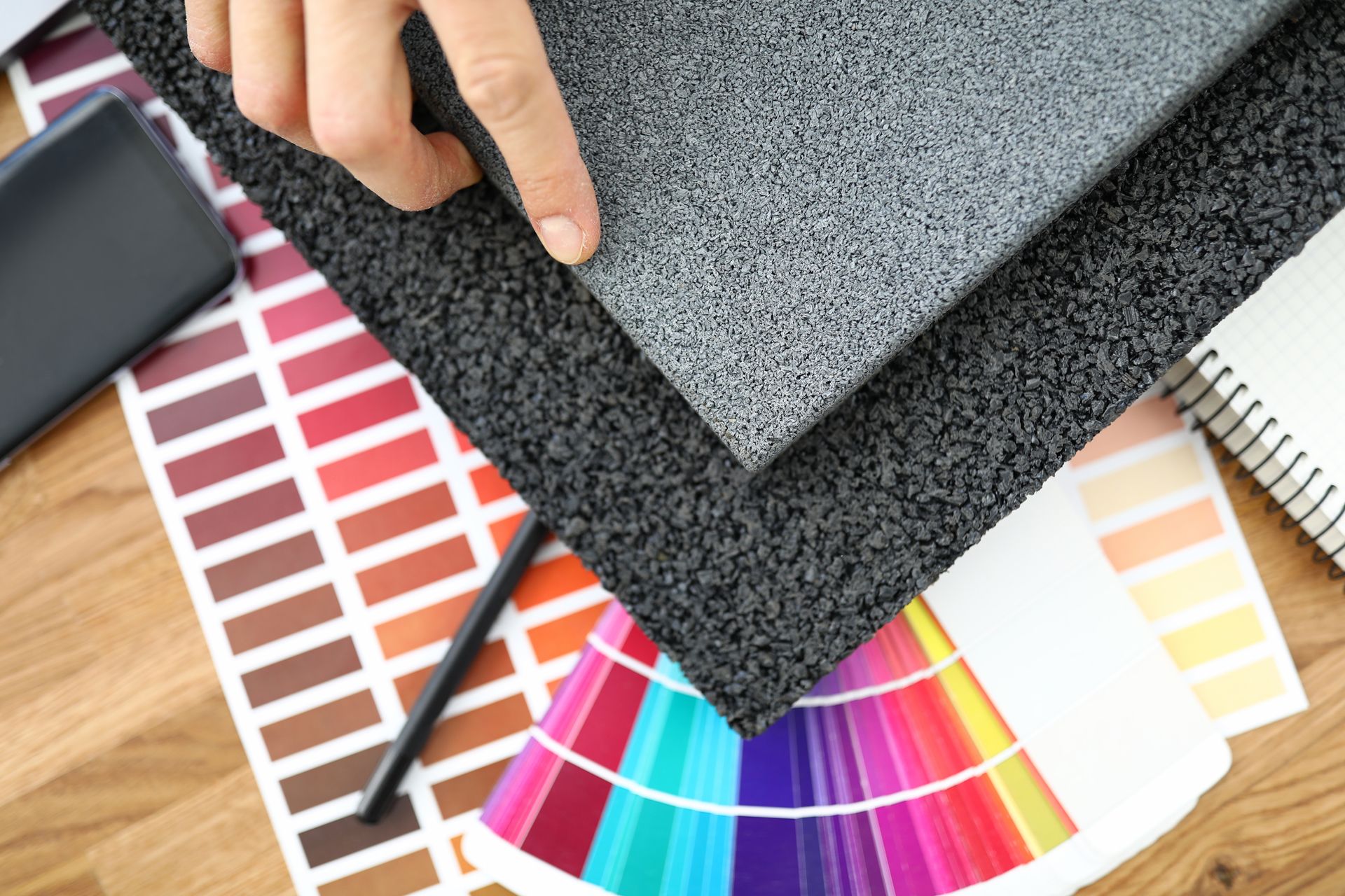 A person is showing a piece of rubber mat. A person is showing a piece of rubber mat.