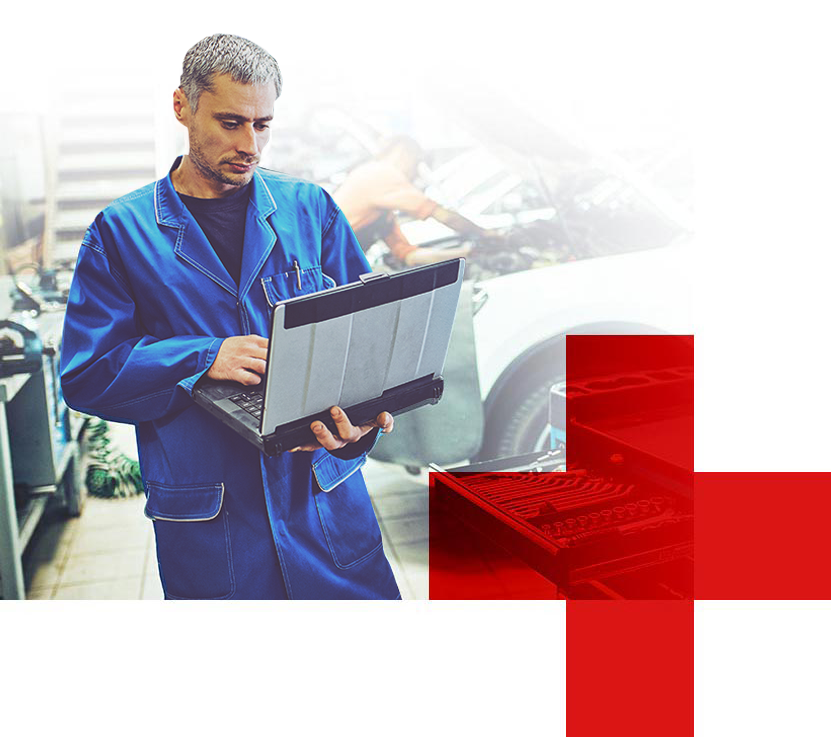 Mechanic in blue coveralls inspecting a car battery in a garage, with a red medical cross graphic overlay. | Automotive Physicians