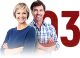Smiling couple standing with arms crossed beside a large red number 3 | Automotive Physicians