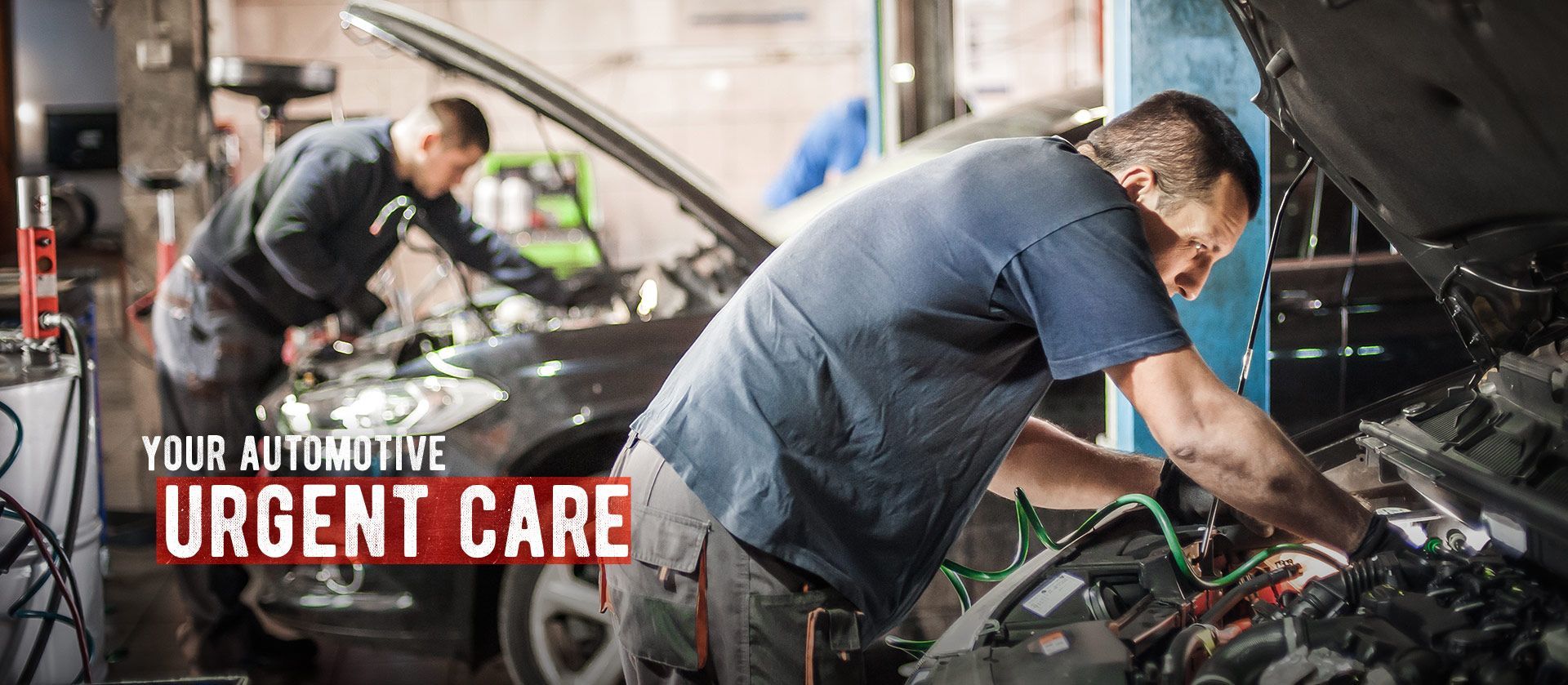 Mechanics working on cars in an auto repair shop with “Your Automotive Urgent Care” text | Automotive Physicians