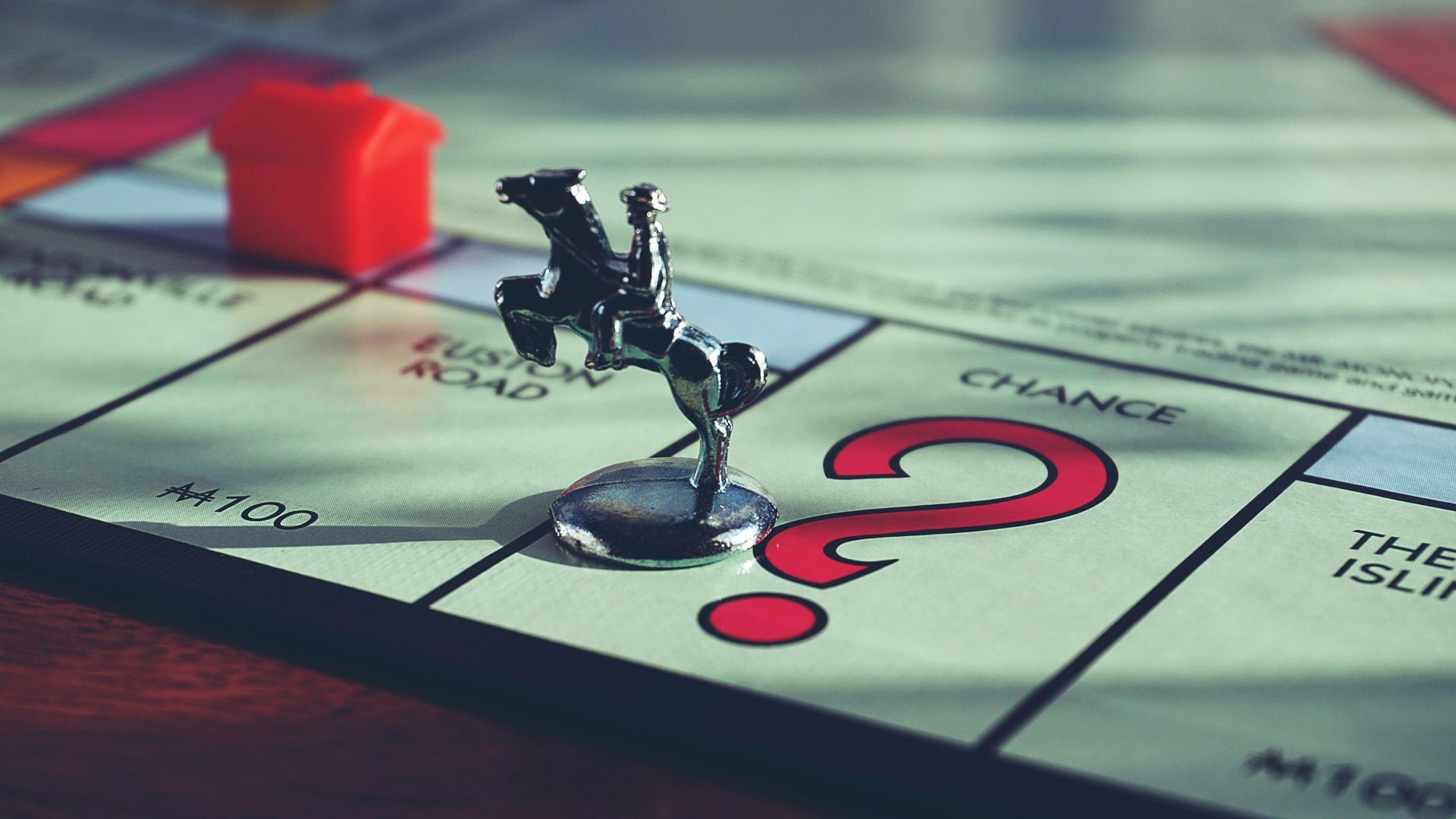 A silver horse and rider game piece stands on the